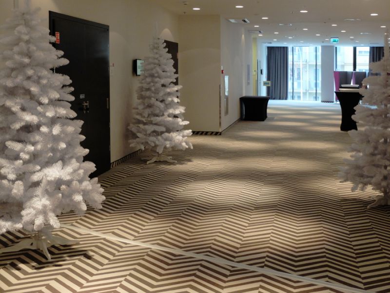  - Silver-white Christmas trees placed in a hotel and conference part of Silver Tower Center in Wrocław 